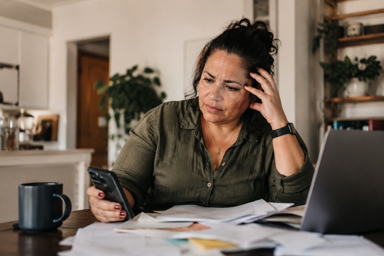 Woman experiencing difficulty concentrating and mental overwhelm associated with ADHD and perimenopause.